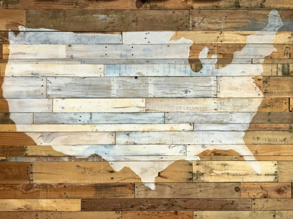 Beautiful wall of a whitewashed silhouette of the country, USA with wood panels.